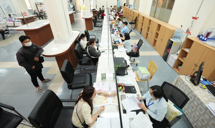 Cán bộ dám nghĩ, dám làm: Ai bảo vệ? - Ảnh 1. Công chức UBND quận Tân Phú, TP.HCM giải quyết thủ tục hành chính - Ảnh: HỮU HẠNH